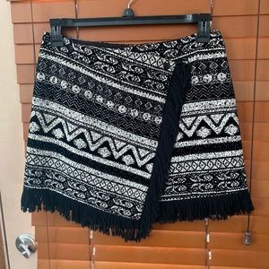 1. STATE ASYMMETRICAL Skirt with fringe on bottom.